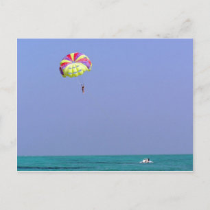 Parasailing over the blue water postcard