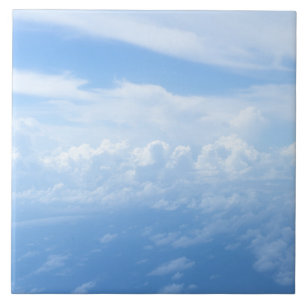 Pastel blue sky, fluffy white clouds tile
