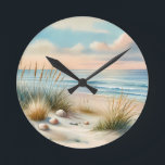 Pastel Coastal Dunes Watercolor Round Clock<br><div class="desc">Soft coastal serenity unfolds through a dreamy watercolor scene of rolling sand dunes, sea oats, scattered shells, and a calm horizon where gentle waves meet a pastel sky. Airy brushstrokes and blended hues of blush, sky blue, seafoam, and warm sand create a tranquil, cottagecore coastal mood that feels both nostalgic...</div>