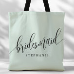 Pastel Mint Bridesmaid Modern Script Tote Bag<br><div class="desc">Show your appreciation to your bridal party with this stylish pastel mint green bridesmaid tote bag. Featuring modern script and customizable with your bridesmaid's name, this tote bag is both practical and elegant. The soft colour and chic design make it perfect for carrying wedding day essentials or everyday items. This...</div>