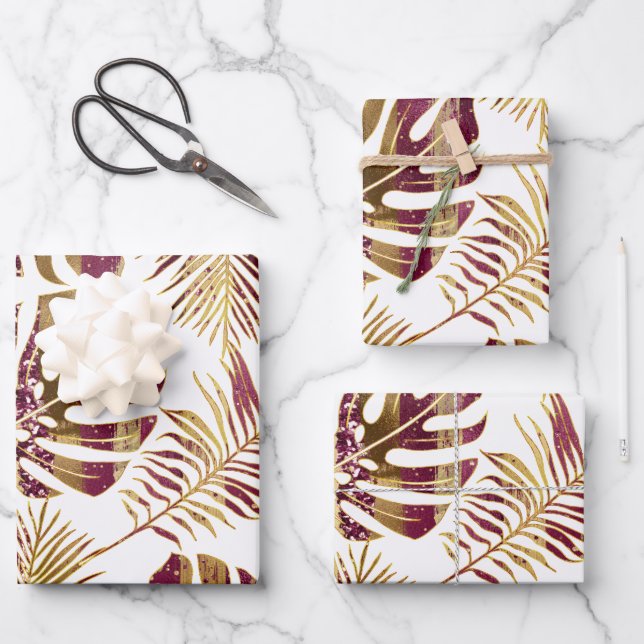 Patterned tropical leaves burgundy and gold wrapping paper sheet (Front)