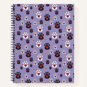 Paw prints with red hearts on blue notebook