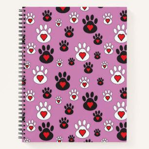 Paw prints with red hearts on pink notebook