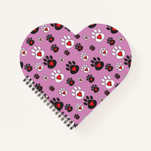 Paw prints with red hearts on pink notebook