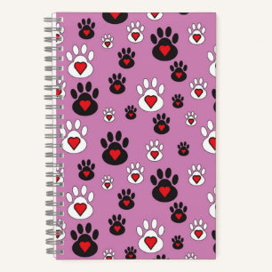 Paw prints with red hearts on pink notebook