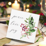 Peace Love Joy Holly Berry Red  Holiday Card<br><div class="desc">A simple modern double sided holiday card in colours of red and white with a watercolor of a bouquet of holly berries and assorted winter greens and peace love and joy in handwritten script typography. The reverse side has a holiday message in a handwritten white font which can be personalized...</div>