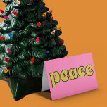 Peace Retro Pink and Lime Green Holiday Card<br><div class="desc">This retro style card features the message "Peace" on the front in lime green letters against a pink background. The inside message can be customized with your own greeting.</div>