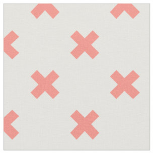 Peach cross stitches on white fabric