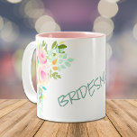 Peach Pink Roses Bridesmaid Wedding Two-Tone Coffee Mug<br><div class="desc">Here's a pretty mug to give to your Bridesmaid as a wedding favour, or at a Bridal Shower. It features a colourful watercolor bouquet of pink, peach, and pale yellow roses with greenery on each side, with your custom text in pastel teal green in the middle. Easily change the word...</div>