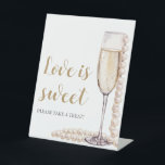 Pearls and Prosecco Champagne Love is Sweet Sign<br><div class="desc">The Pearls and Prosecco Champagne Love is Sweet Sign is a charming and elegant addition to any wedding or special event. With its sophisticated design featuring pearls and prosecco champagne, this sign adds a touch of romance and luxury to the celebration. Whether displayed on a dessert table, candy bar, or...</div>
