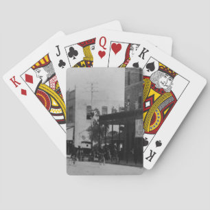 Pedestrians, cyclists, and horse-carriages playing cards