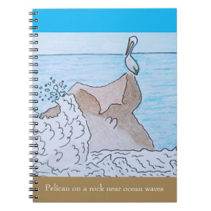 Pelican on a rock near ocean waves notebook
