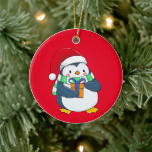 Penguin in a Christmas hat with a gift Ceramic Ornament