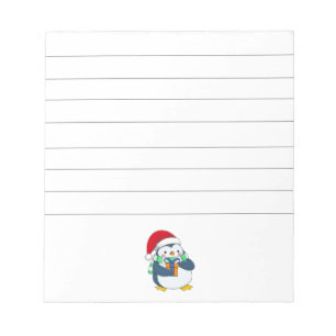 Penguin in a Christmas hat with a gift Notepad