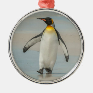 Penguin walking on the beach metal ornament