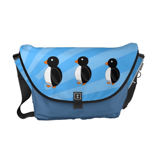 Penguins on blue sunburst messenger bag