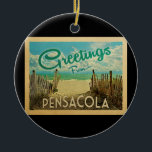 Pensacola Beach Vintage Travel Ceramic Ornament<br><div class="desc">This Greetings From Pensacola vintage postcard design features a sandy beach with a beautiful turquoise ocean water and above the sea,  a blue sky with billowy white clouds. In vintage travels style.</div>
