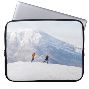 People having fun and running in mountains on the laptop sleeve