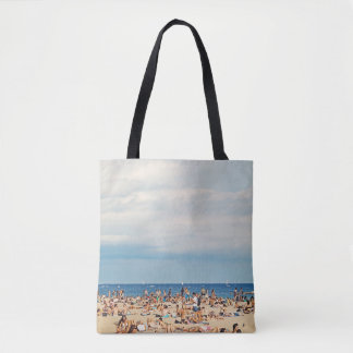 People on brown sand beach tote bag