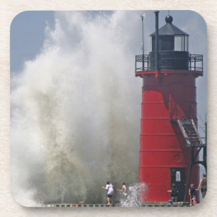 People on jetty watch large breaking waves in coaster