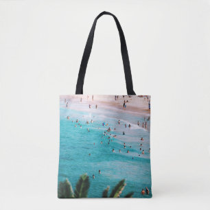 People swimming in the beach tote bag
