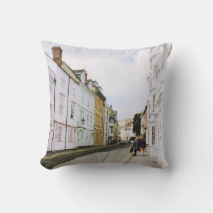 PEOPLE WALKING ON SIDEWALK BESIDE BUILDING AND ROA THROW PILLOW