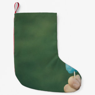 Person holding ice pop small christmas stocking