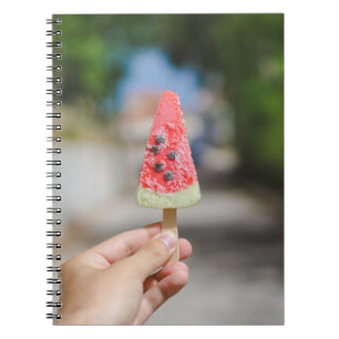 Person holding popsicle in the morning notebook