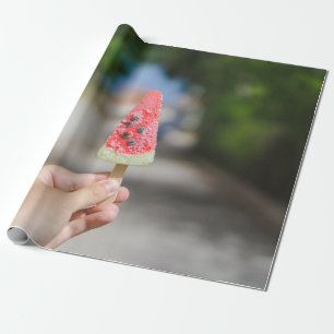 Person holding popsicle in the morning wrapping paper