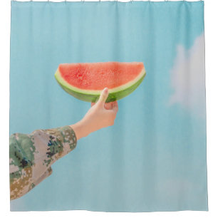 Person holding sliced watermelon