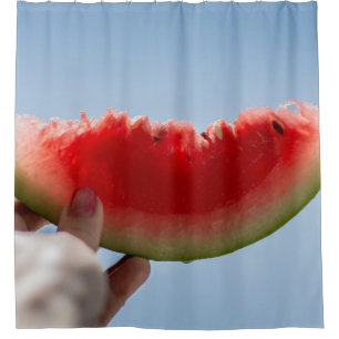 Person holding sliced watermelon