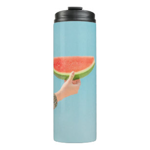 Person holding sliced watermelon thermal tumbler