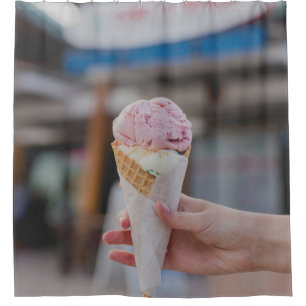 Person holding strawberry ice cream