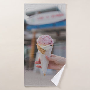 Person holding strawberry ice cream bath towel