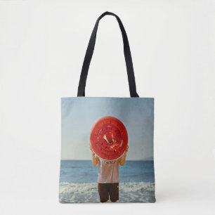 Person holding watermelon-themed inflatable ring tote bag