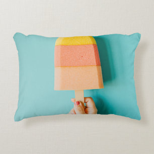 Person holding yellow and brown ice cream cone accent pillow