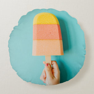 Person holding yellow and brown ice cream cone round pillow