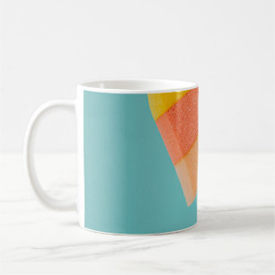 Person holding yellow and pink popsicle coffee mug