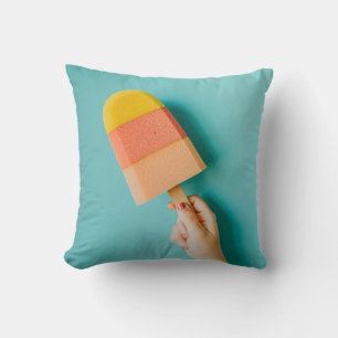 Person holding yellow and pink popsicle throw pillow
