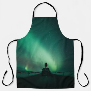 PERSON STANDING IN FRONT OF AURORA LIGHTS APRON