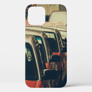 PERSON STANDING NEAR PARKED TAXI DURING DAYTIME iPhone 12 CASE
