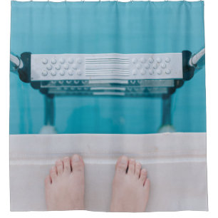 Person standing on swimming pool ladder