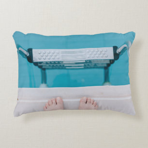 Person standing on swimming pool ladder accent pillow