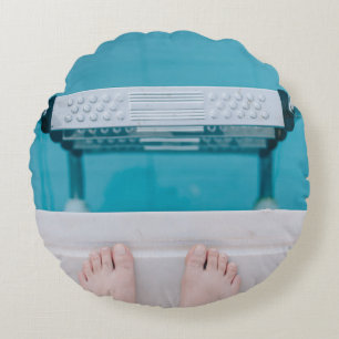 Person standing on swimming pool ladder round pillow