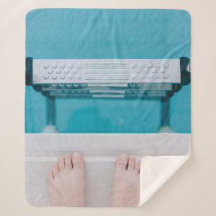 Person standing on swimming pool ladder sherpa blanket