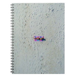 Person sunbathing at the beach notebook