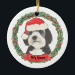 Personalized Bernedoodle Red and Green Santa Hat Ceramic Ornament<br><div class="desc">I am in love with this beautifully detailed watercolor illustration of a grey, black, and white bernedoodle or sheepadoodle on an ornament in a sweet santa hat! Personalize these pastel ornaments and make the nice list this year! For the perfect presents, pair it with a matching item from the collection...</div>