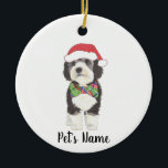 Personalized Bernedoodle Santa Hat & Bowtie Ceramic Ornament<br><div class="desc">I am in love with this beautifully detailed watercolor illustration of a grey, black, and white bernedoodle or sheepadoodle on a an ornament with a sweet little red and green bow tie and santa hat combo! Personalize these ornaments and make the nice list this year! For the perfect presents, pair...</div>