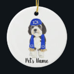 Personalized Bernedoodle Yarmulke Hanukkah Blue Ceramic Ornament<br><div class="desc">I am in love with this beautifully detailed watercolor illustration of a grey, black, and white bernedoodle or sheepadoodle on a an ornament with a sweet little blue yarmulke and scarf combo! Personalize these ornaments and make the nice list this year! For the perfect presents, pair it with a matching...</div>