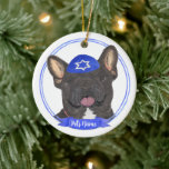 Personalized Black Brindle Frenchie Hanukkah Ceramic Ornament<br><div class="desc">Celebrate your favourite mensch on a bench with a personalized ornament! This design features a sweet illustration of a black or brindle french bulldog dog with a blue and white yarmulke. For the most thoughtful gifts, pair it with another item from my collection! To see more work and learn about...</div>